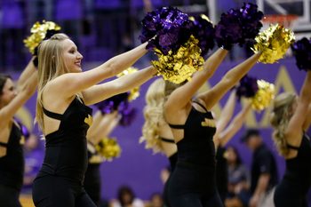 Nov 14, 2014; Harrisonburg, VA, USA; A James Madison Dukes cheerleader dances on the court during a stoppage in play against the Virginia Cavaliers at JMU Convocation Center. The Cavaliers won 79-51. Mandatory Credit: Amber Searls-Imagn Images
