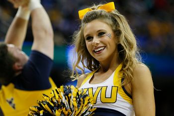 Mar 26, 2015; Cleveland, OH, USA; West Virginia Mountaineers cheerleader during the first half against the Kentucky Wildcats in the semifinals of the midwest regional of the 2015 NCAA Tournament at Quicken Loans Arena. Mandatory Credit: Rick Osentoski-Imagn Images