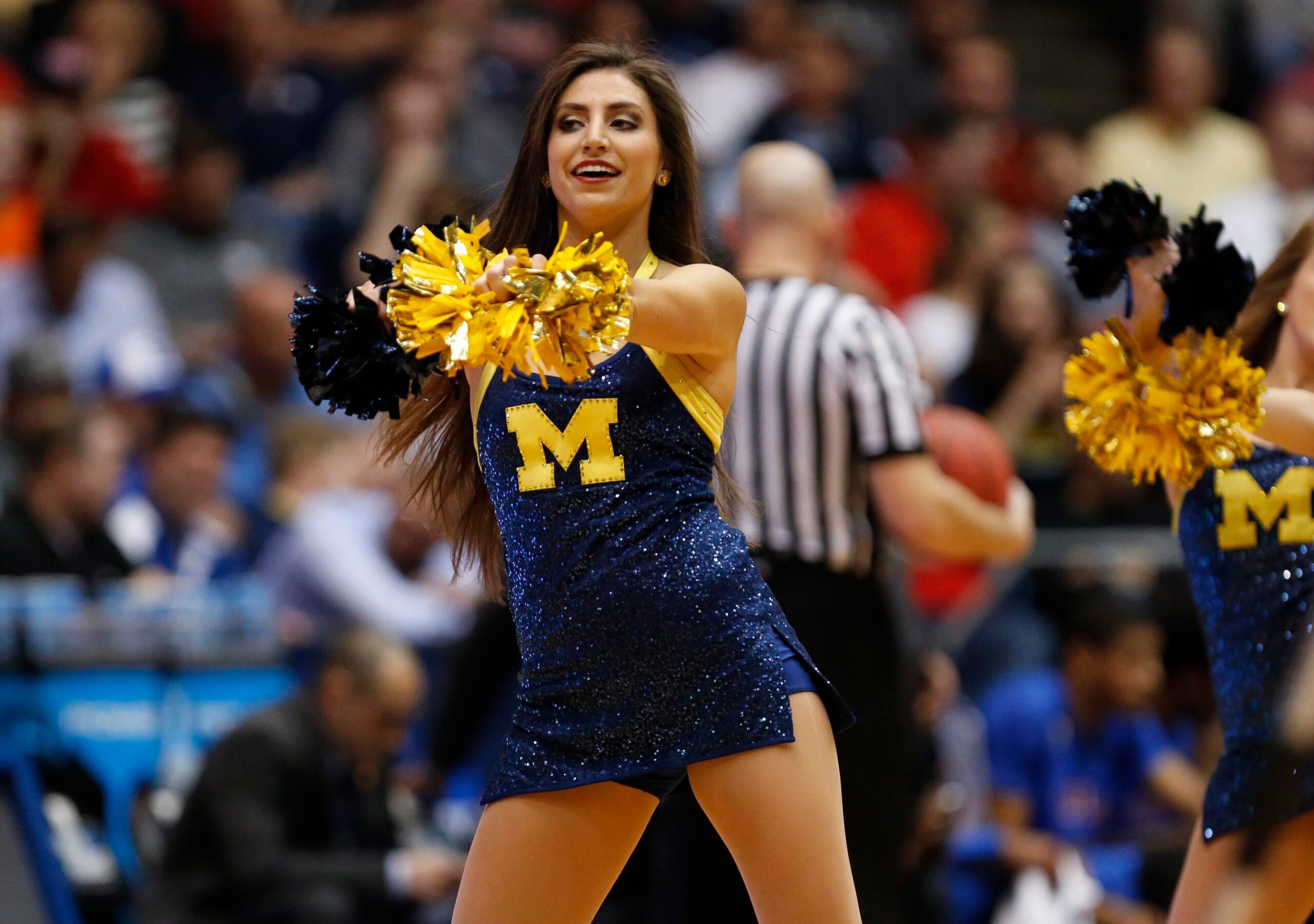 Mar 16, 2016; Dayton, OH, USA; Michigan Wolverines cheerleader performs during the first half against the Tulsa Golden Hurricane in the First Four of the NCAA men's college basketball tournament at Dayton Arena. Mandatory Credit: Rick Osentoski-Imagn Images