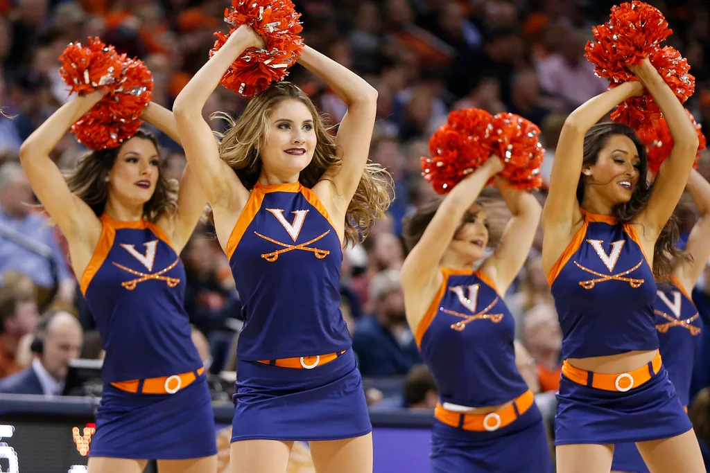 Feb 10, 2018; Charlottesville, VA, USA; Virginia Cavaliers cheerleaders perform on the court during a stoppage in play during the second half against the Virginia Tech Hokies at John Paul Jones Arena. Mandatory Credit: Amber Searls-Imagn Images