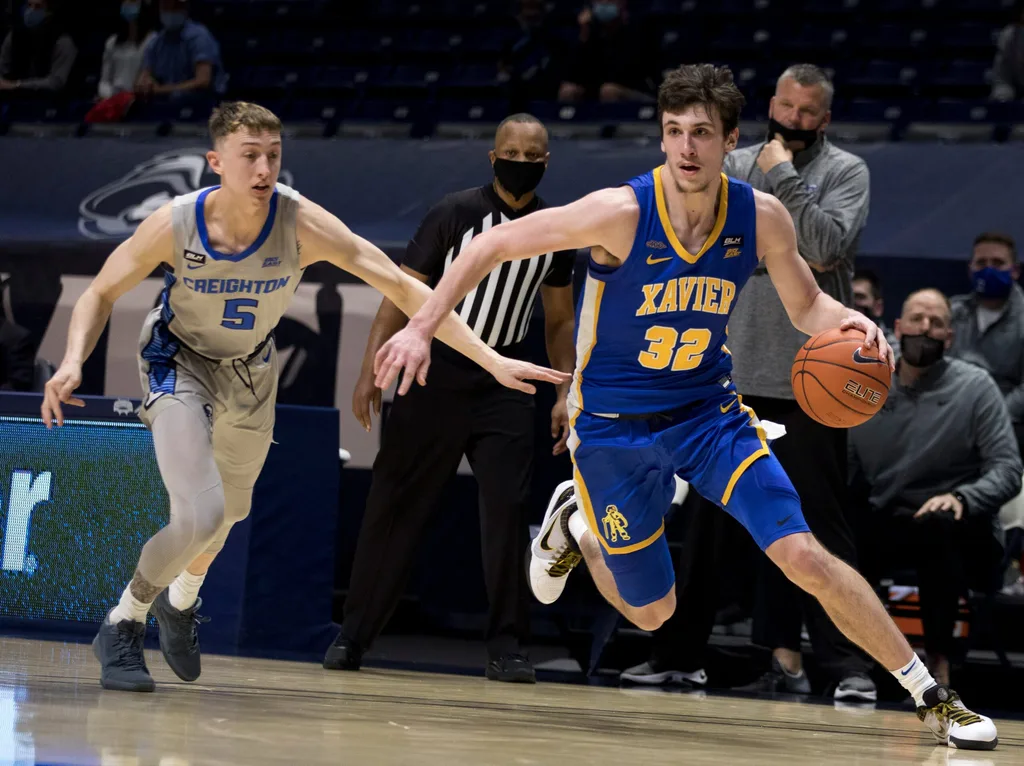 Xavier Musketeers forward Zach Freemantle (32) drives passed Creighton Bluejays guard Alex O'Connell (5) in the first half of the men's NCAA basketball game on Saturday, Feb. 27, 2021, at the Cintas Center in Cincinnati.
Xavier Musketeers Creighton Bluejays