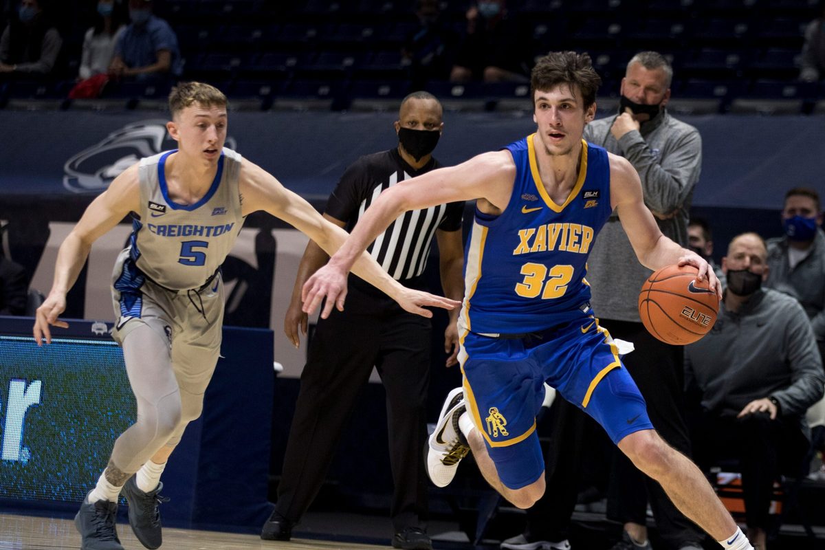 Xavier Musketeers forward Zach Freemantle (32) drives passed Creighton Bluejays guard Alex O'Connell (5) in the first half of the men's NCAA basketball game on Saturday, Feb. 27, 2021, at the Cintas Center in Cincinnati.
Xavier Musketeers Creighton Bluejays