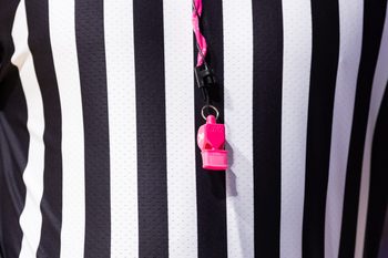 Jan 24, 2024; Gainesville, Florida, USA; SEC referee Joe Lindsey hangs a pink breast cancer awareness whistle around his neck during the first half between the Florida Gators and the Mississippi State Bulldogs at Exactech Arena at the Stephen C. O'Connell Center. Mandatory Credit: Matt Pendleton-Imagn Images