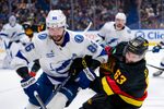 Dec 8, 2024; Vancouver, British Columbia, CAN; Tampa Bay Lightning forward Nikita Kucherov (86) checks Vancouver Canucks forward Max Sasson (63) during the second period at Rogers Arena. Mandatory Credit: Bob Frid-Imagn Images