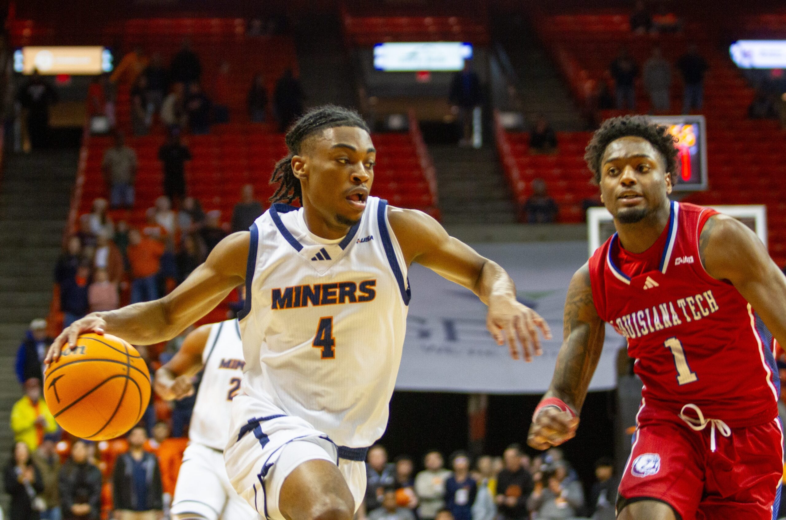 UTEP's Corey Camper Jr. (4) attempts to dribble past Louisiana Tech's Amaree Abram (1) at the Don Haskins Center in El Paso, Texas, on Jan. 2, 2025.