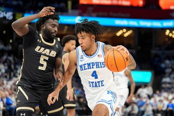 Memphis' PJ Haggerty (4) drives to the basket as UAB’s Tyren Moore (5) guards him during the game between University of Memphis and University of Alabama at Birmingham at FedExForum on Sunday, January 26, 2025, in Memphis, Tenn.