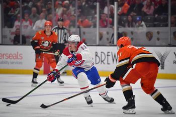 Feb 2, 2025; Anaheim, California, USA; Montreal Canadiens right wing Brendan Gallagher (11) moves the puck against Anaheim Ducks defenseman Olen Zellweger (51) during the third period at Honda Center. Mandatory Credit: Gary A. Vasquez-Imagn Images