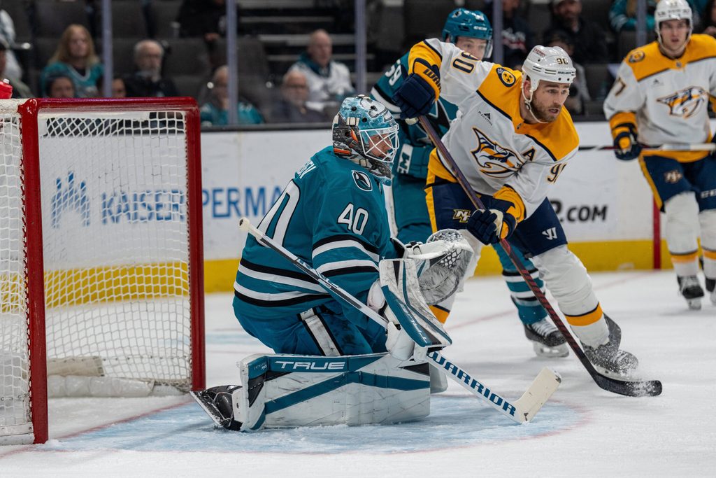 Mar 11, 2025; San Jose, California, USA; Nashville Predators center Colton Sissons (10) and San Jose Sharks defenseman Jimmy Schuldt (59) battle for position in front of the net during the first period at SAP Center at San Jose. Mandatory Credit: Neville E. Guard-Imagn Images