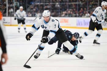 Mar 14, 2025; Seattle, Washington, USA; Utah Hockey Club defenseman Michael Kesselring (7) plays the puck during the second period against the Seattle Kraken at Climate Pledge Arena. Mandatory Credit: Steven Bisig-Imagn Images