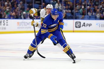 Mar 15, 2025; Buffalo, New York, USA;  Buffalo Sabres center Tage Thompson (72) skates with the puck as Vegas Golden Knights left wing Pavel Dorofeyev (16) defends during overtime at KeyBank Center. Mandatory Credit: Timothy T. Ludwig-Imagn Images