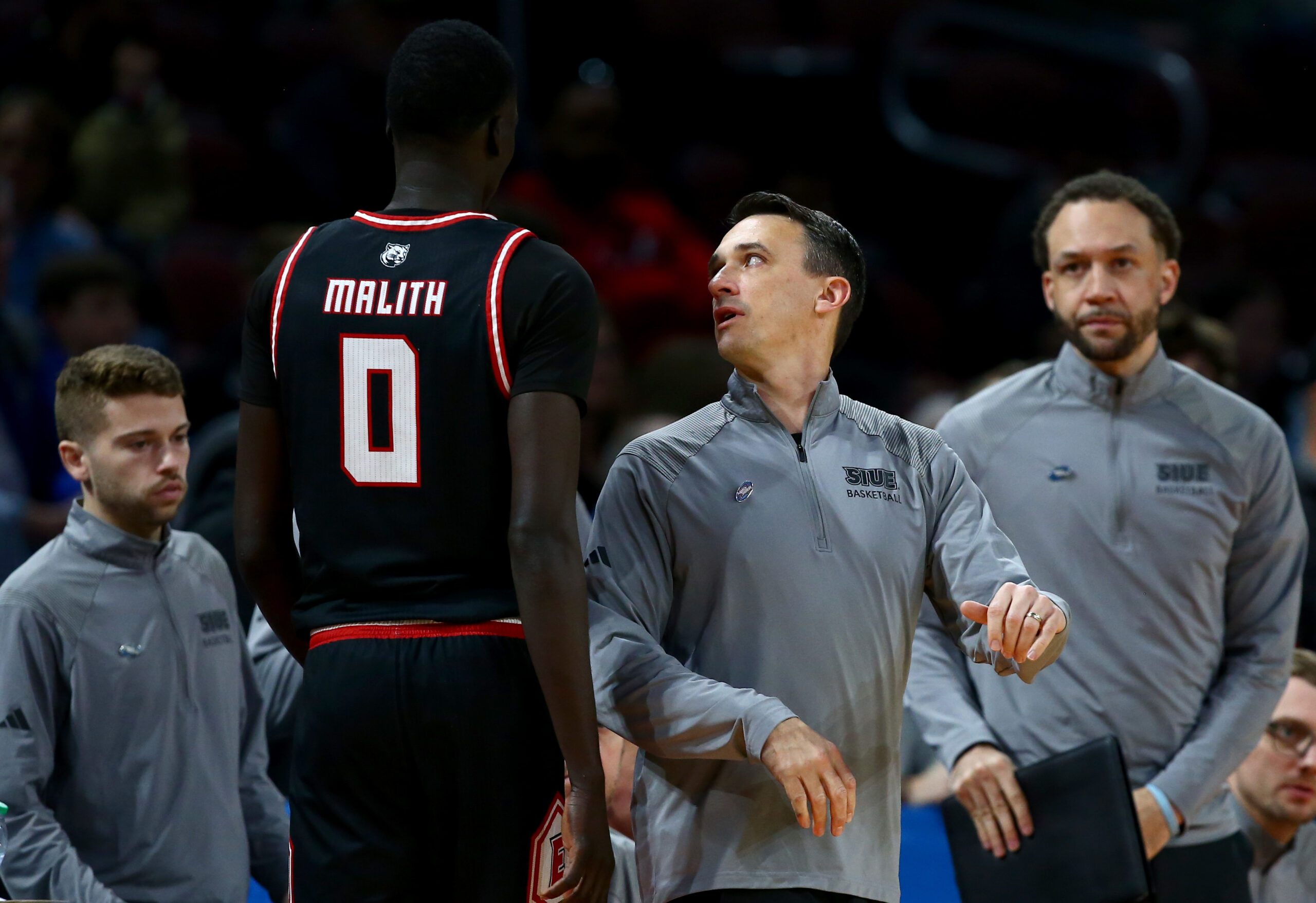 Mar 20, 2025; Wichita, KS, USA; SIU Edwardsville Cougars head coach Brian Barone talks to forward Ring Malith (0) in the second half of a first round men’s NCAA Tournament game against the Houston Cougars at Intrust Bank Arena. Mandatory Credit: Nick Tre. Smith-Imagn Images