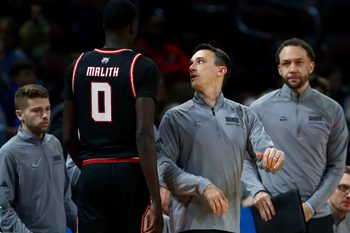 Mar 20, 2025; Wichita, KS, USA; SIU Edwardsville Cougars head coach Brian Barone talks to forward Ring Malith (0) in the second half of a first round men’s NCAA Tournament game against the Houston Cougars at Intrust Bank Arena. Mandatory Credit: Nick Tre. Smith-Imagn Images
