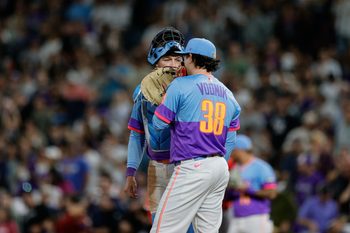 Sep 19, 2025; Denver, Colorado, USA; Colorado Rockies catcher Hunter Goodman (15) talks with relief pitcher Victor Vodnik (38) in the ninth inning against the Los Angeles Angels at Coors Field. Mandatory Credit: Isaiah J. Downing-Imagn Images