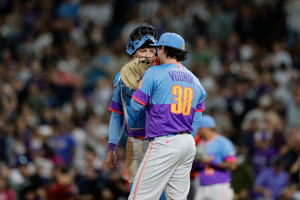 Sep 19, 2025; Denver, Colorado, USA; Colorado Rockies catcher Hunter Goodman (15) talks with relief pitcher Victor Vodnik (38) in the ninth inning against the Los Angeles Angels at Coors Field. Mandatory Credit: Isaiah J. Downing-Imagn Images