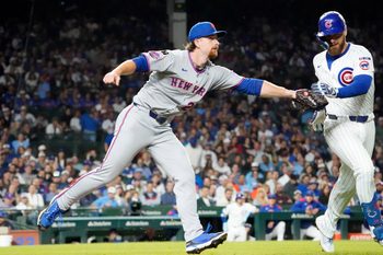 Sep 25, 2025; Chicago, Illinois, USA; New York Mets pitcher Nolan McLean (26) tags out Chicago Cubs first base Michael Busch (29) during the fifth inning at Wrigley Field. Mandatory Credit: David Banks-Imagn Images