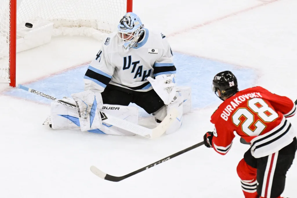 Oct 13, 2025; Chicago, Illinois, USA; Chicago Blackhawks left wing Andre Burakovsky (28) scores past Utah Mammoth goaltender Vitek Vanecek (41) during the third period at United Center. Mandatory Credit: Matt Marton-Imagn Images