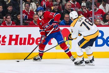 Oct 16, 2025; Montreal, Quebec, CAN; Montreal Canadiens center Kirby Dach (77) plays the puck against Nashville Predators defenseman Brady Skjei (76) during the second period at Bell Centre. Mandatory Credit: David Kirouac-Imagn Images