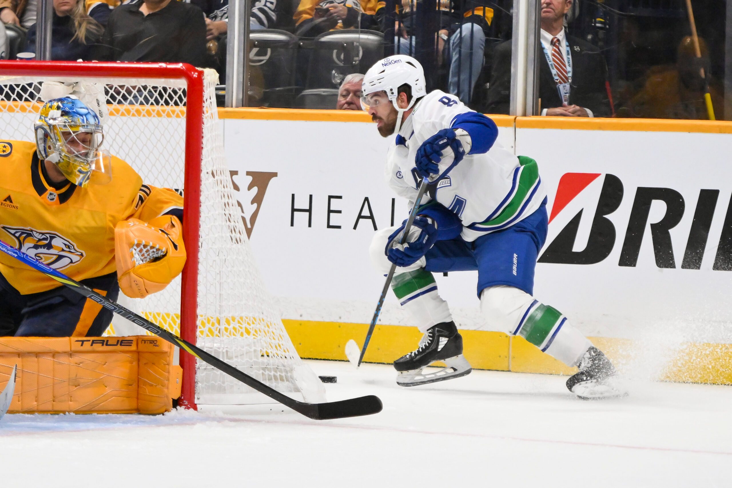 Oct 23, 2025; Nashville, Tennessee, USA;  Vancouver Canucks right wing Conor Garland (8) skates behind the net against the Nashville Predators during the second period at Bridgestone Arena. Mandatory Credit: Steve Roberts-Imagn Images