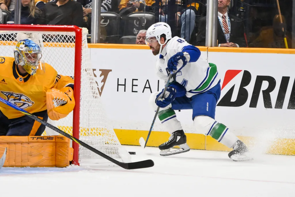 Oct 23, 2025; Nashville, Tennessee, USA; Vancouver Canucks right wing Conor Garland (8) skates behind the net against the Nashville Predators during the second period at Bridgestone Arena. Mandatory Credit: Steve Roberts-Imagn Images