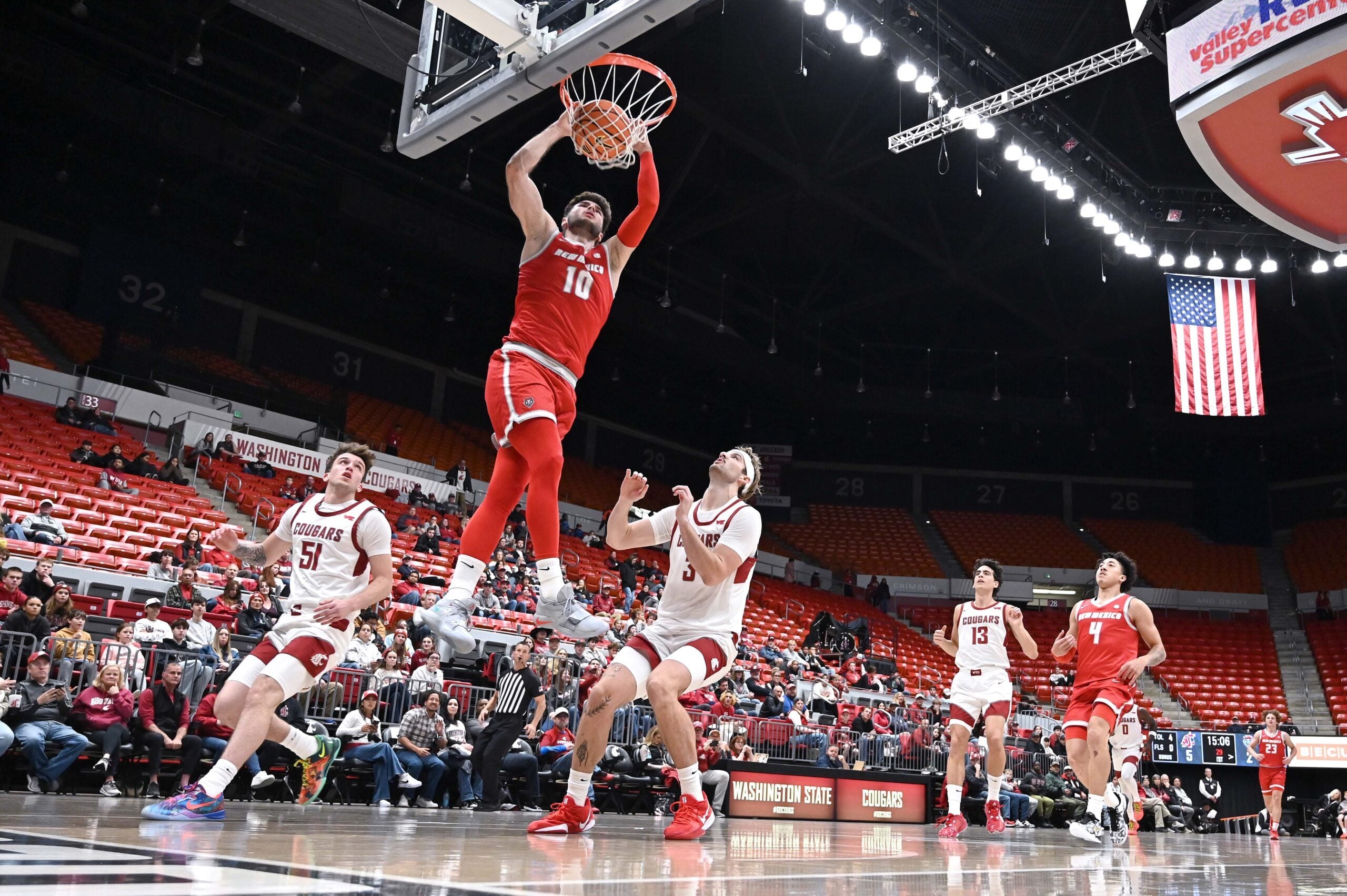 Oct 25, 2025; Pullman, WA, USA; New Mexico Lobos forward Tomislav Buljan (10) dunks the ball against Washington State Cougars forward Simon Hildebrandt (3) in the first half at Friel Court at Beasley Coliseum. Mandatory Credit: James Snook-Imagn Images