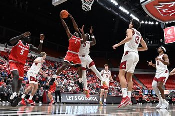 Oct 25, 2025; Pullman, WA, USA; New Mexico Lobos guard Deyton Albury (1) shoots the ball against Washington State Cougars forward Emmanuel Ugbo (0) in the second half at Friel Court at Beasley Coliseum. Washington State Cougars won 74-66. Mandatory Credit: James Snook-Imagn Images