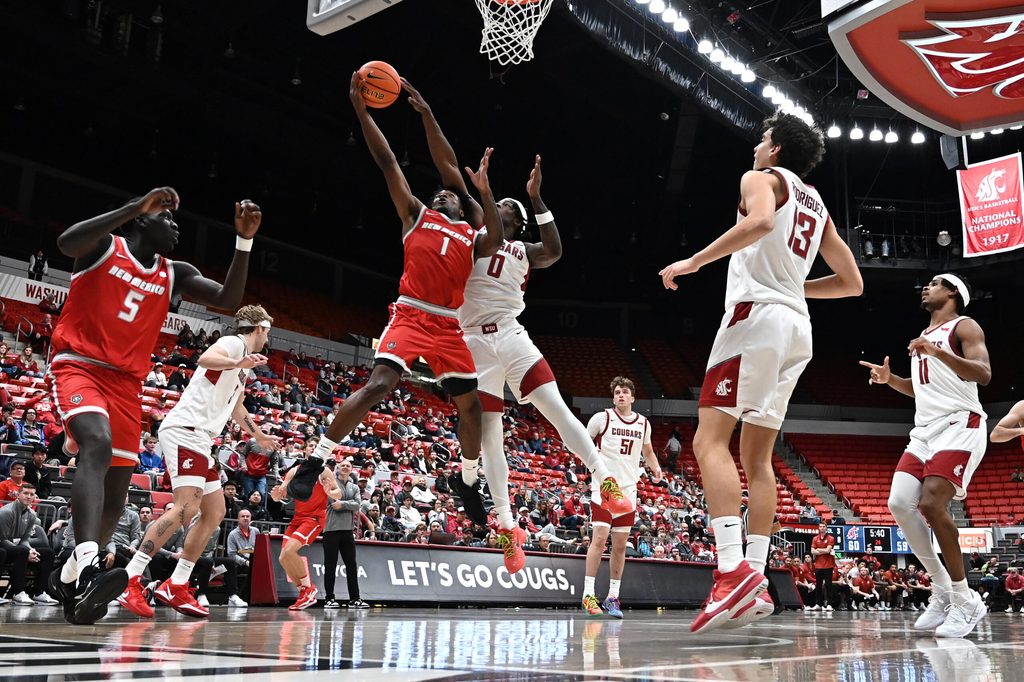 Oct 25, 2025; Pullman, WA, USA; New Mexico Lobos guard Deyton Albury (1) shoots the ball against Washington State Cougars forward Emmanuel Ugbo (0) in the second half at Friel Court at Beasley Coliseum. Washington State Cougars won 74-66. Mandatory Credit: James Snook-Imagn Images