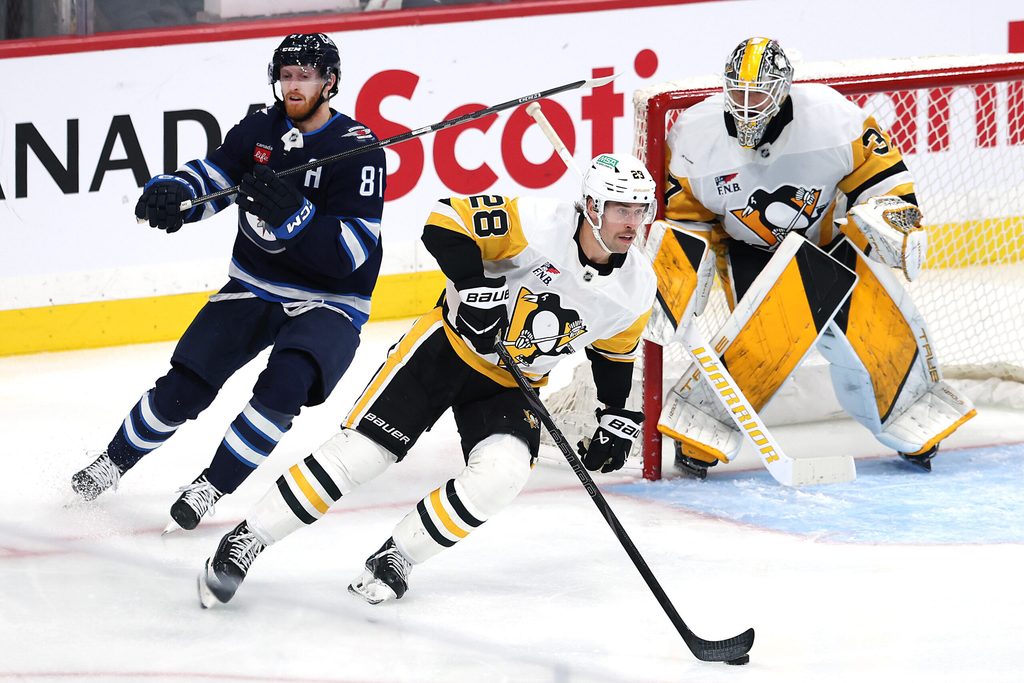 Nov 1, 2025; Winnipeg, Manitoba, CAN; Pittsburgh Penguins defenseman Parker Wotherspoon (28) is chased down by Winnipeg Jets left wing Kyle Connor (81) in front of Pittsburgh Penguins goaltender Arturs Silovs (37) in the third period at Canada Life Centre. Mandatory Credit: James Carey Lauder-Imagn Images
