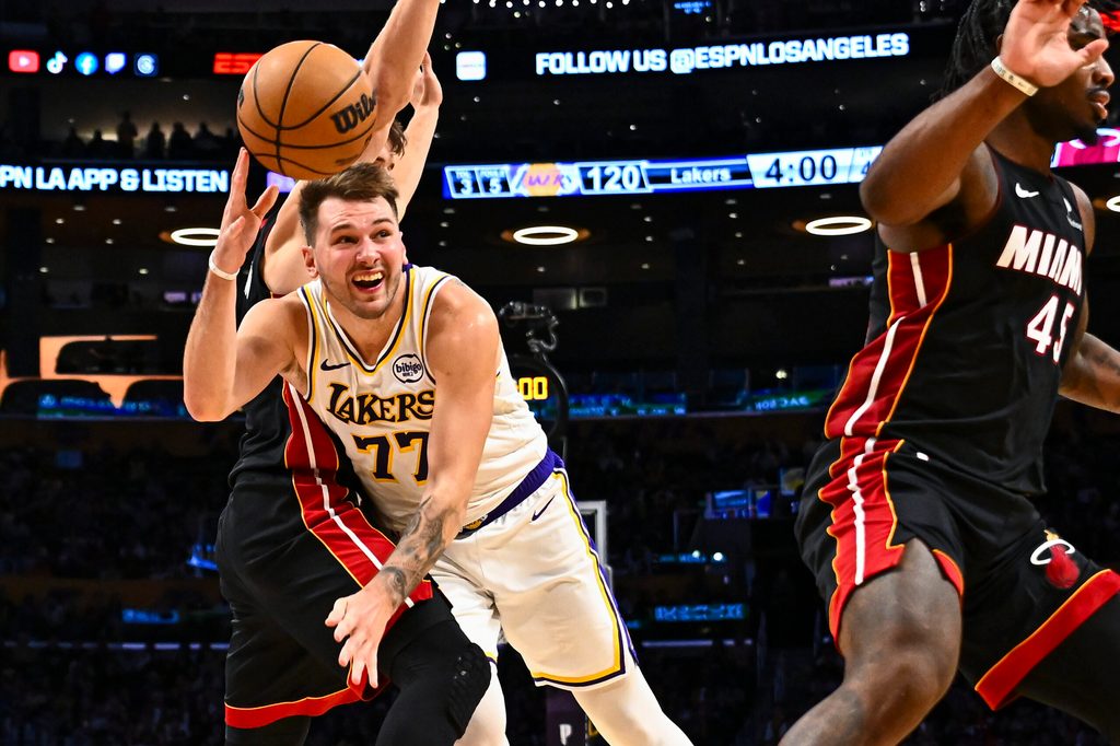 Nov 2, 2025; Los Angeles, California, USA; Los Angeles Lakers guard Luka Doncic (77) passes the ball against Miami Heat guard Pelle Larsson (9) during the second half at Crypto.com Arena. Mandatory Credit: Jonathan Hui-Imagn Images