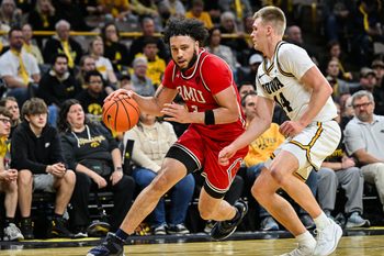 Nov 4, 2025; Iowa City, Iowa, USA; Robert Morris Colonials guard Ryan Prather Jr. (2) goes to the basket as Iowa Hawkeyes guard Bennett Stirtz (14) defends during the first half at Carver-Hawkeye Arena. Mandatory Credit: Jeffrey Becker-Imagn Images