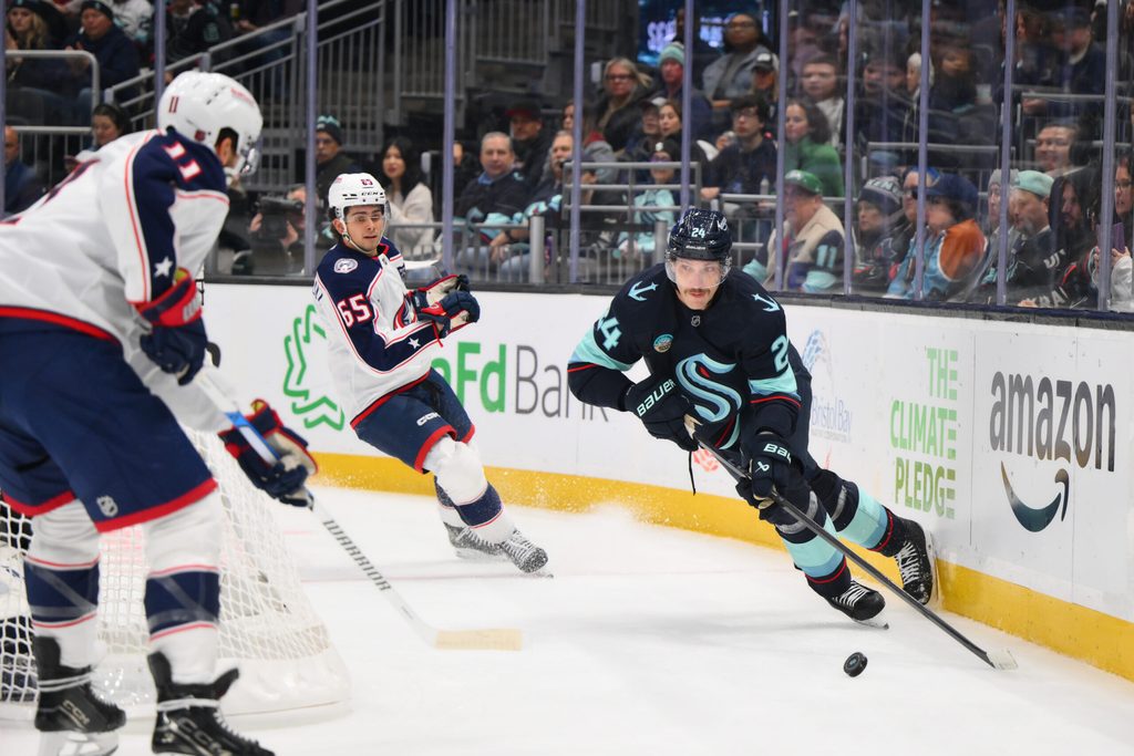 Nov 11, 2025; Seattle, Washington, USA; Seattle Kraken defenseman Jamie Oleksiak (24) plays the puck during the first period against the Columbus Blue Jackets at Climate Pledge Arena. Mandatory Credit: Steven Bisig-Imagn Images