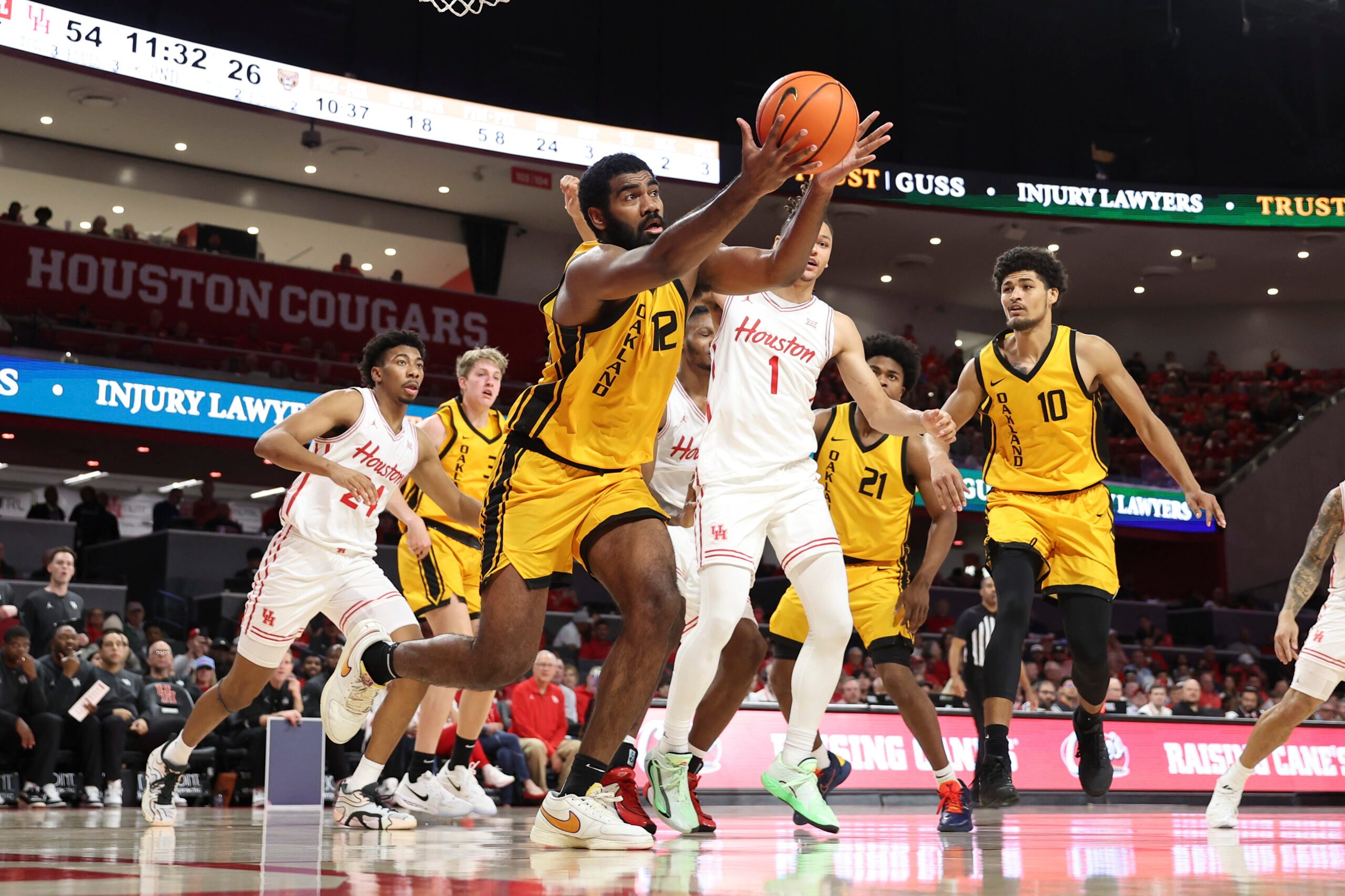 Nov 12, 2025; Houston, Texas, USA; Oakland Golden Grizzlies forward Tuburu Naivalurua (12) attemtps to get a rebound during the second half against the Houston Cougars at Fertitta Center. Mandatory Credit: Troy Taormina-Imagn Images