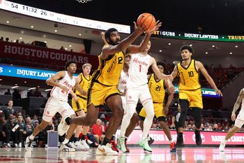 Nov 12, 2025; Houston, Texas, USA; Oakland Golden Grizzlies forward Tuburu Naivalurua (12) attemtps to get a rebound during the second half against the Houston Cougars at Fertitta Center. Mandatory Credit: Troy Taormina-Imagn Images
