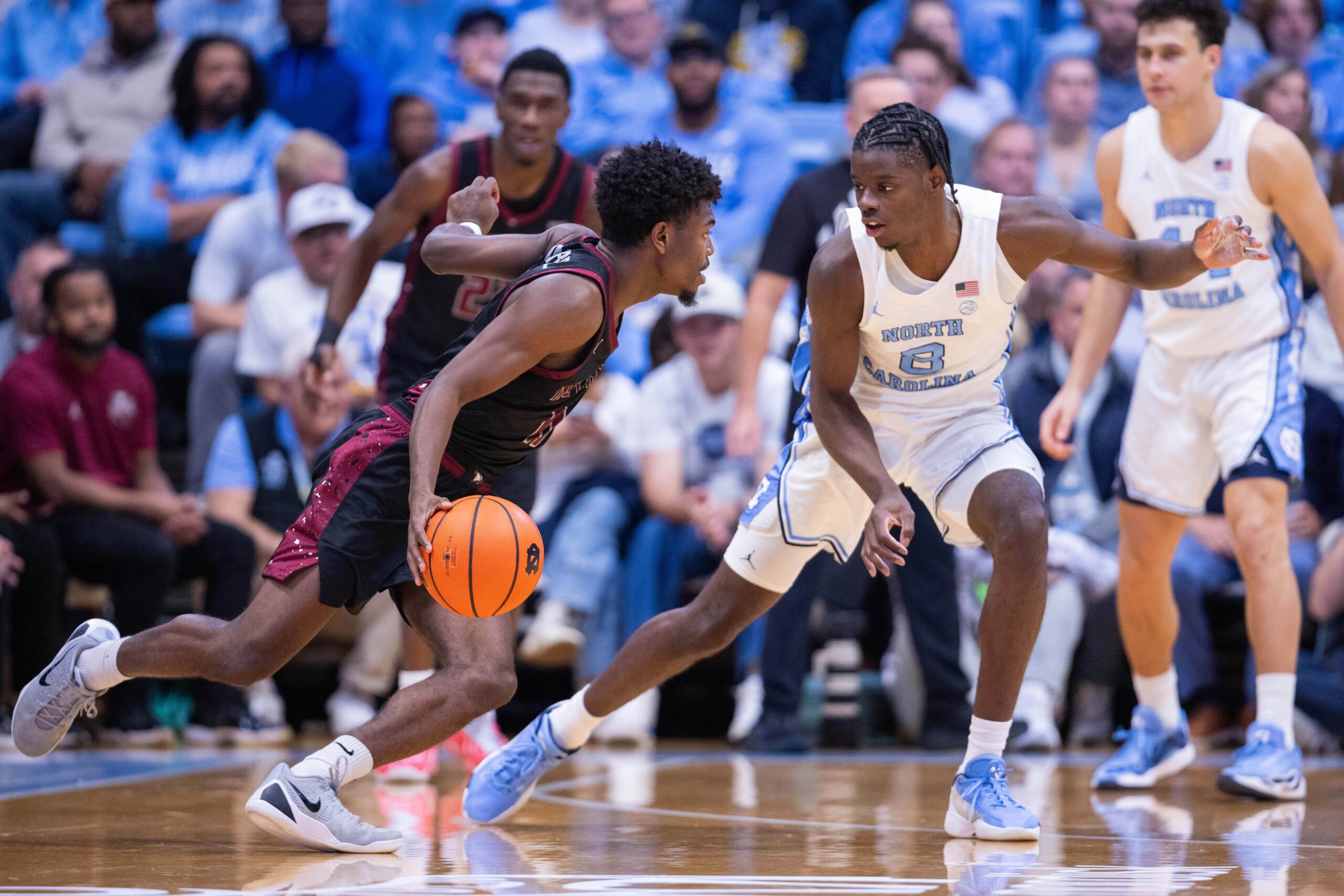 Nov 14, 2025; Chapel Hill, North Carolina, USA; North Carolina Tar Heels forward Caleb Wilson (8) guards North Carolina Central Eagles guard Gage Lattimore (11) during the second half at Dean E. Smith Center. Mandatory Credit: Scott Kinser-Imagn Images