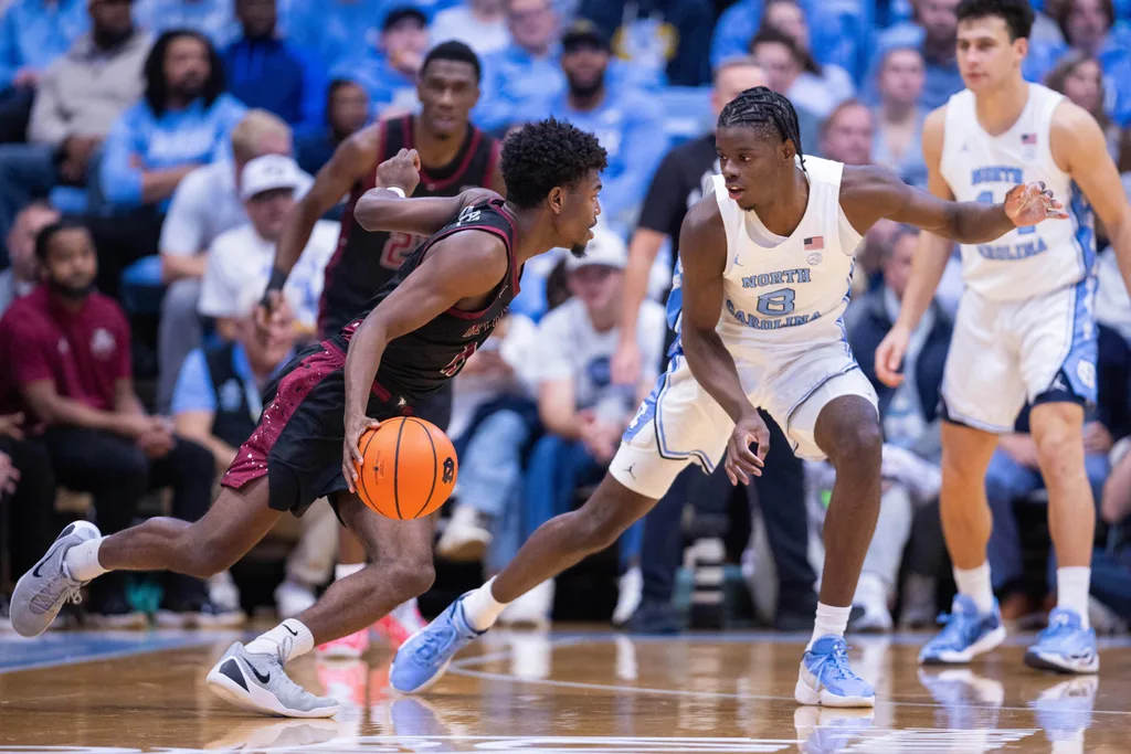 Nov 14, 2025; Chapel Hill, North Carolina, USA; North Carolina Tar Heels forward Caleb Wilson (8) guards North Carolina Central Eagles guard Gage Lattimore (11) during the second half at Dean E. Smith Center. Mandatory Credit: Scott Kinser-Imagn Images
