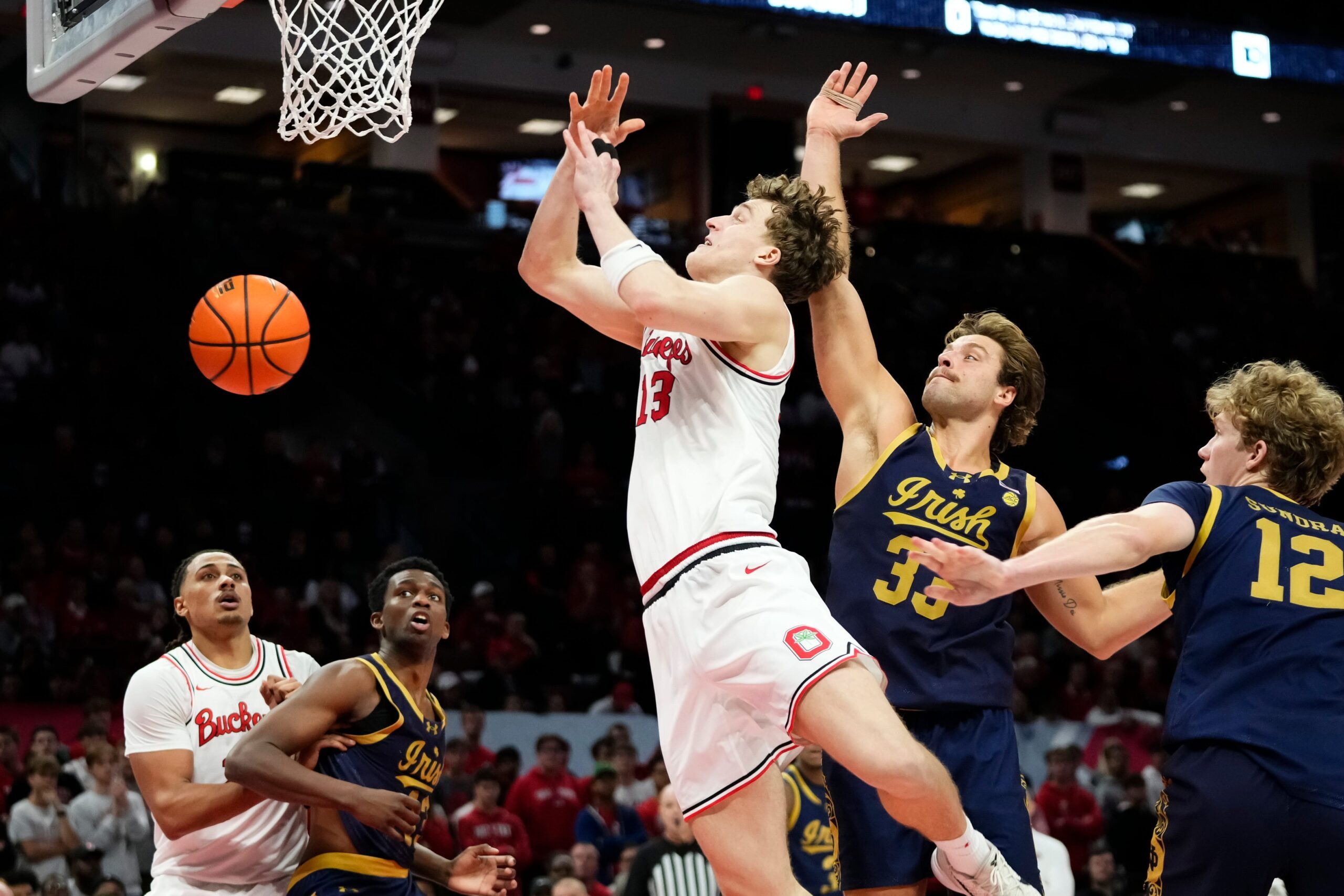 Notre Dame Fighting Irish forward Carson Towt (33) blocks the shot of Ohio State Buckeyes center Christoph Tilly (13) during the men's NCAA basketball game at Value City Arena in Columbus on Nov. 16, 2025. Ohio State won 64-63.