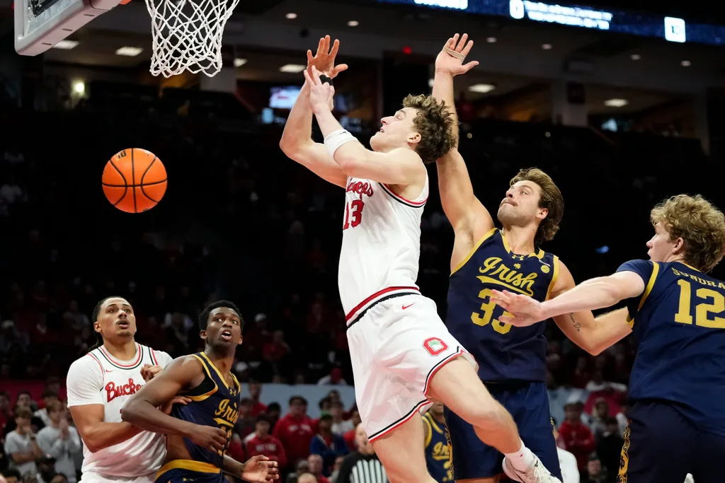 Notre Dame Fighting Irish forward Carson Towt (33) blocks the shot of Ohio State Buckeyes center Christoph Tilly (13) during the men's NCAA basketball game at Value City Arena in Columbus on Nov. 16, 2025. Ohio State won 64-63.