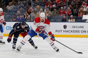 Nov 17, 2025; Columbus, Ohio, USA; Montreal Canadiens defenseman Arber Xhekaj (72) controls the puck as Columbus Blue Jackets left wing Miles Wood (11) trails the play during the second period at Nationwide Arena. Mandatory Credit: Russell LaBounty-Imagn Images