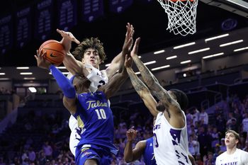 Nov 17, 2025; Manhattan, Kansas, USA; Tulsa Golden Hurricane guard Tylen Riley (10) is guarded by Kansas State Wildcats center Dorin Buca (22) and guard David Castillo (10) during the second half at Bramlage Coliseum. Mandatory Credit: Scott Sewell-Imagn Images