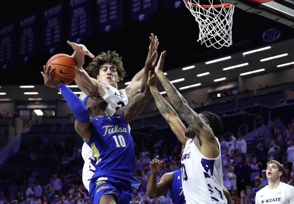 Nov 17, 2025; Manhattan, Kansas, USA; Tulsa Golden Hurricane guard Tylen Riley (10) is guarded by Kansas State Wildcats center Dorin Buca (22) and guard David Castillo (10) during the second half at Bramlage Coliseum. Mandatory Credit: Scott Sewell-Imagn Images