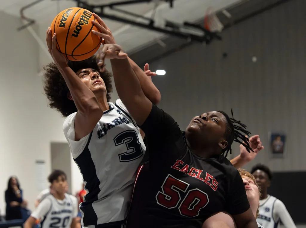Nov 17, 2025; Northport, Alabama, USA; North River's Austin Harmon (3) battles for a shot agaisnt Victory Christian's Reben Skinner (50) at North River Christian Academy’s home gym at New Beginning Family Worship Center.