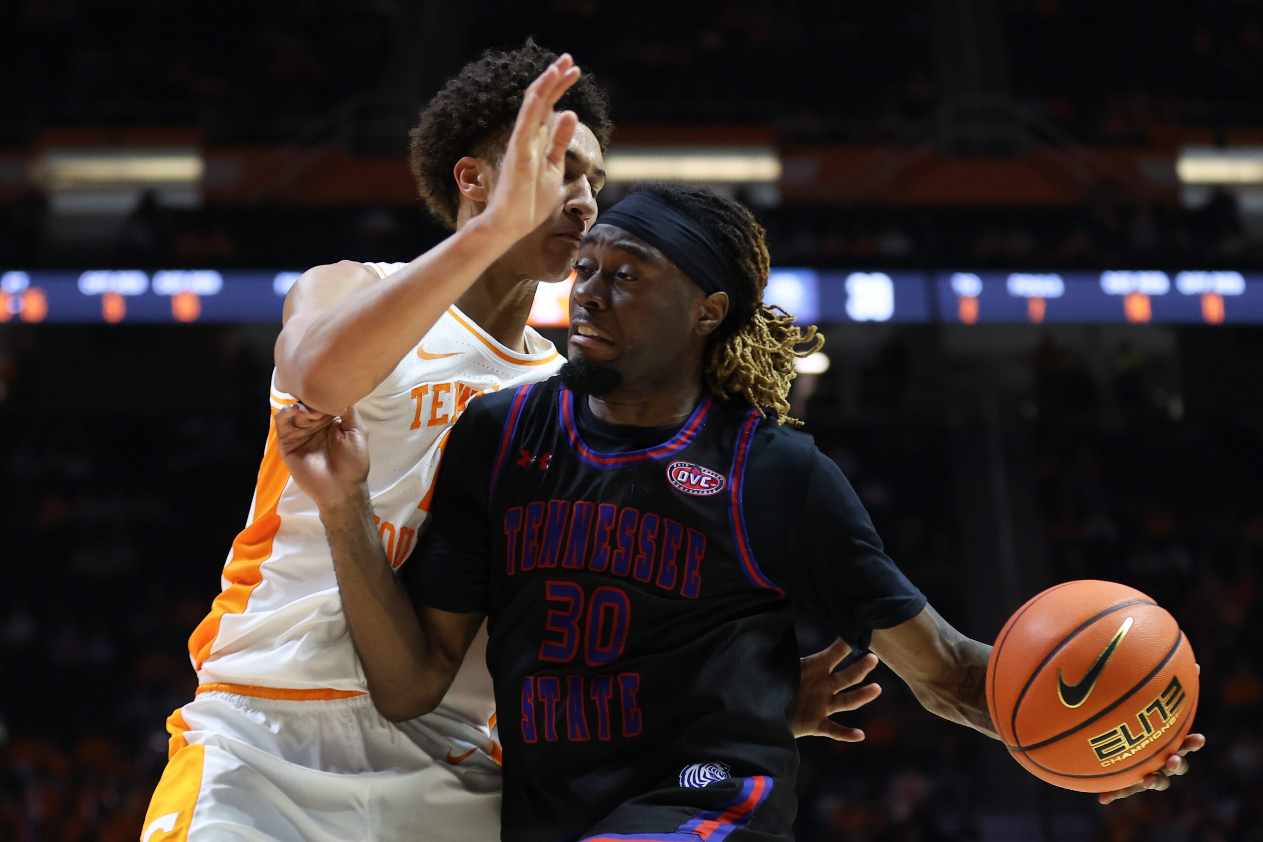 Nov 20, 2025; Knoxville, Tennessee, USA;  Tennessee State Tigers forward Aaron Nkrumah (30) moves the ball against Tennessee Volunteers forward Nate Ament (10) during the second half at Thompson-Boling Arena at Food City Center. Mandatory Credit: Randy Sartin-Imagn Images