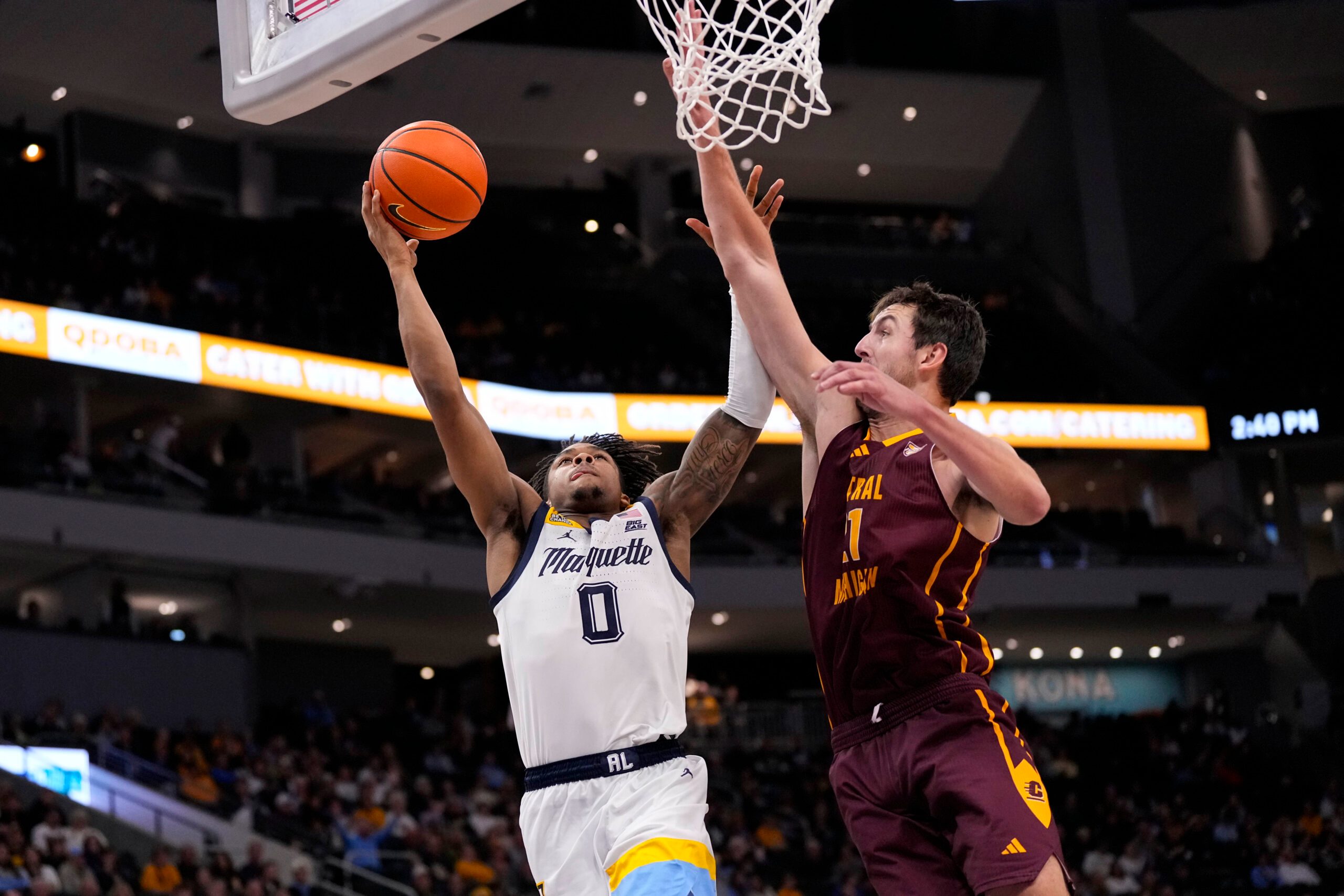 Nov 22, 2025; Milwaukee, Wisconsin, USA;  Marquette Golden Eagles guard Nigel James Jr. (0) shoots against Central Michigan Chippewas forward Nick Mullen (21) during the second half at Fiserv Forum. Mandatory Credit: Jeff Hanisch-Imagn Images