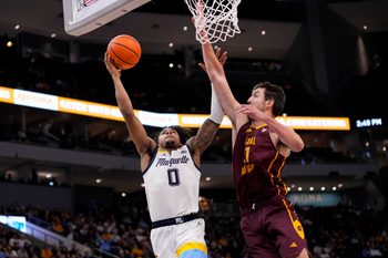 Nov 22, 2025; Milwaukee, Wisconsin, USA;  Marquette Golden Eagles guard Nigel James Jr. (0) shoots against Central Michigan Chippewas forward Nick Mullen (21) during the second half at Fiserv Forum. Mandatory Credit: Jeff Hanisch-Imagn Images