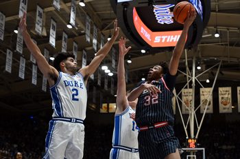 Nov 23, 2025; Durham, North Carolina, USA;  Howard Bison forward Travelle Bryson (32) shoots the ball over Duke Blue Devils guard Cayden Boozer (2) during the first half at Cameron Indoor Stadium. Mandatory Credit: Rob Kinnan-Imagn Images
