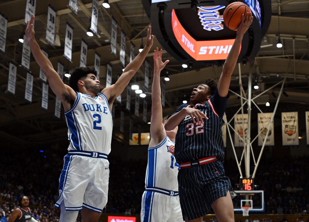 Nov 23, 2025; Durham, North Carolina, USA; Howard Bison forward Travelle Bryson (32) shoots the ball over Duke Blue Devils guard Cayden Boozer (2) during the first half at Cameron Indoor Stadium. Mandatory Credit: Rob Kinnan-Imagn Images