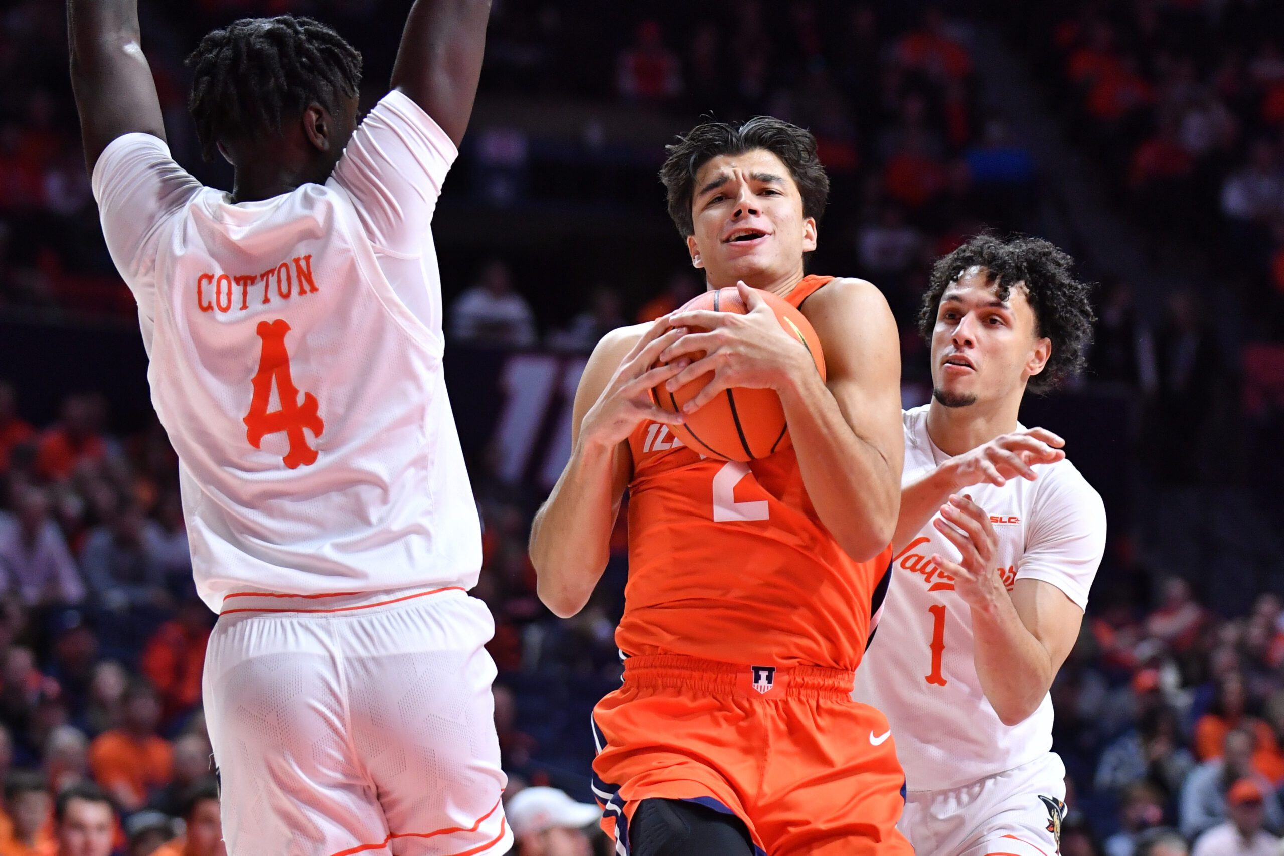 Nov 24, 2025; Champaign, Illinois, USA;  Illinois Fighting Illini guard Andrej Stojakovic (2) grabs a rebound between UT Rio Grande Valley Vaqueros guard Koree Cotton (4) and  Always Wright (1) during the first half at State Farm Center. Mandatory Credit: Ron Johnson-Imagn Images