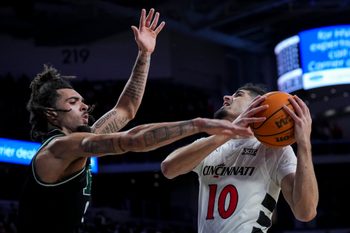 Nov 26, 2025; Cincinnati, Ohio, USA;  Cincinnati Bearcats guard Shon Abaev (10) drives to the basket against Eastern Michigan Eagles guard Addison Patterson (9) in the second half at Fifth Third Arena. Mandatory Credit: Aaron Doster-Imagn Images