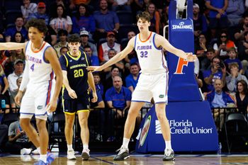 Nov 21, 2025; Gainesville, Florida, USA; Florida Gators center Olivier Rioux (32) defends Merrimack Warriors forward Todd Brogna (20) during the second half at Exactech Arena at the Stephen C. O'Connell Center. Mandatory Credit: Matt Pendleton-Imagn Images