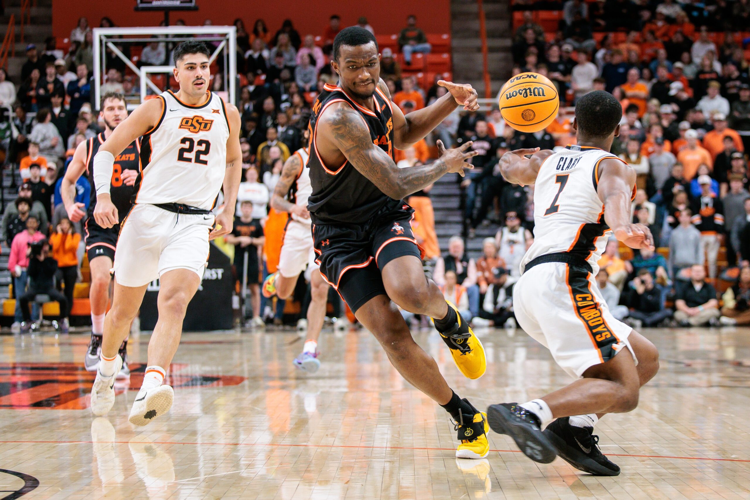 Dec 2, 2025; Stillwater, Oklahoma, USA; Oklahoma State Cowboys guard Kirk Cole (7) steals the ball from Sam Houston Bearkats forward Veljko Ilic (8) during the second half at Gallagher-Iba Arena. Mandatory Credit: William Purnell-Imagn Images