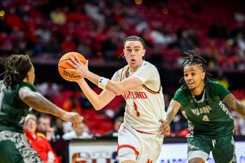 Dec 2, 2025; College Park, Maryland, USA;  Maryland Terrapins guard Darius Adams (1) makes a move to the basket on Wagner Seahawks guard John Awoke (4) during the second half at Xfinity Center. Mandatory Credit: Tommy Gilligan-Imagn Images
